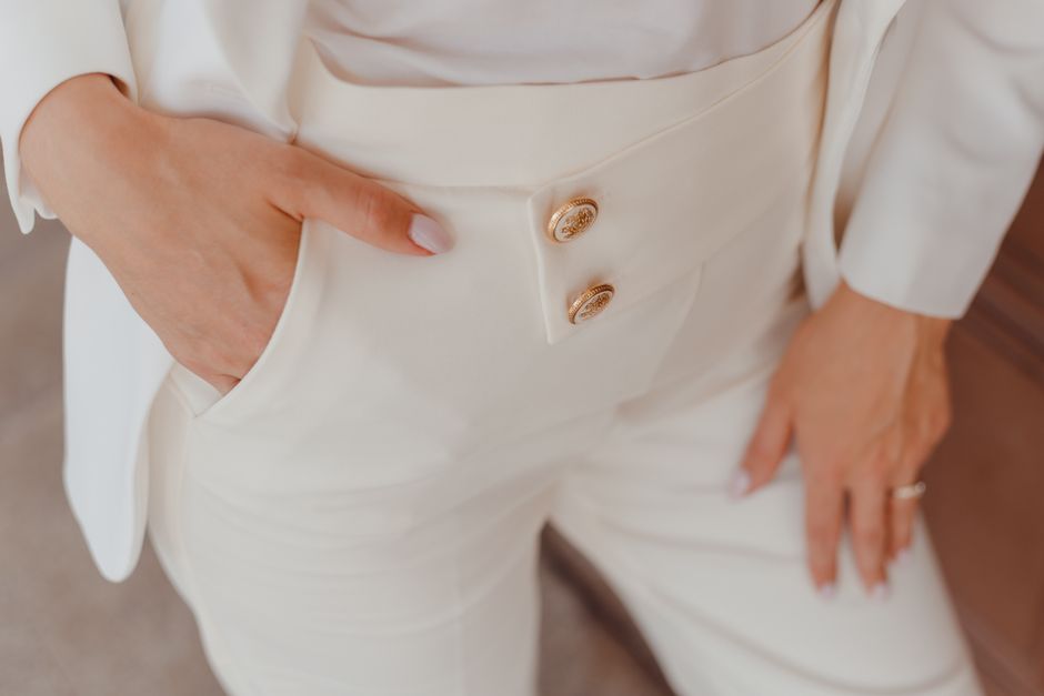 Close-up of a woman's white pantsuit showcasing elegant design and style.