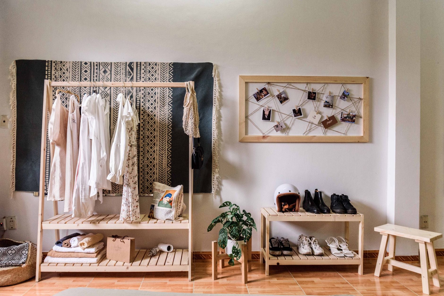 Stylish room with minimalist wardrobe and decor, showcasing clothing and shoes.