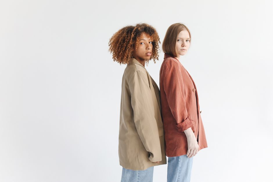 Portrait of two diverse women in stylish jackets showcasing modern fashion trends.
