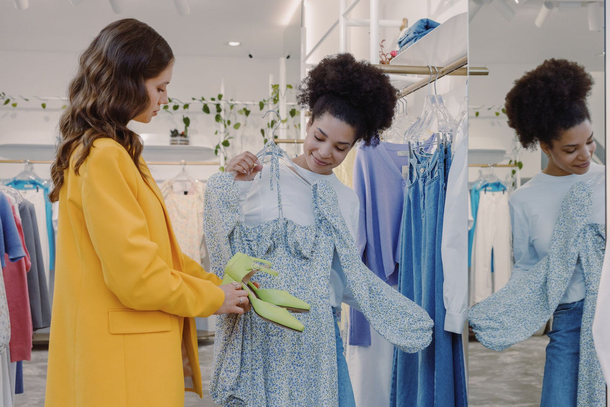 Two women exploring stylish clothing in a trendy boutique. Perfect for fashion and shopping concepts.